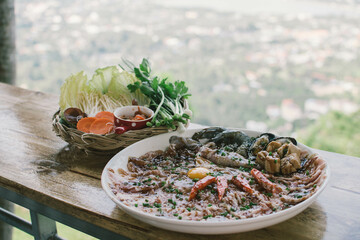 Thai traditional barbecue pork on grilled aluminium pan with soup canal (Moo Krata), barbecue party on wooden table with fingers handle chopsticks