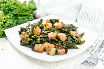 Kale cabbage with bacon in plate on board