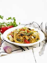 Spaghetti buckwheat with vegetables in plate on napkin