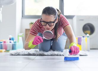 Obsessed woman cleaning the bathroom floor at home