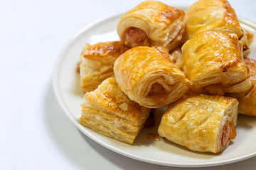 Homemade mini sausage puff pastry on plate.