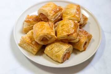 Homemade mini sausage puff pastry on plate.