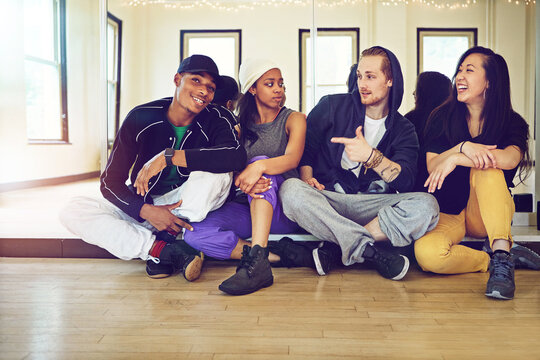Studio, dancers or friends in portrait while happy for practice break, resting or relaxing together. Dancing school, crew or talent people with skills, men and women for hip hop rehearsal for battle - Powered by Adobe
