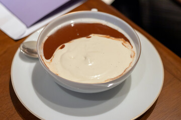 Creamy vanilla custard is topped a rich chocolate sauce, making for a truly indulgent treat.