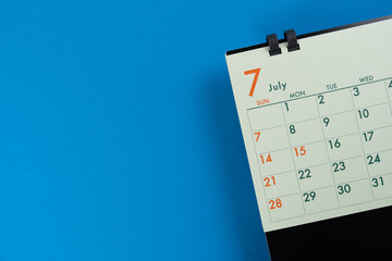 close up of calendar on the blue table background, planning for business meeting or travel planning concept