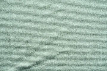 Clothing fabric green texture background, close up of cloth textile surface abstract.