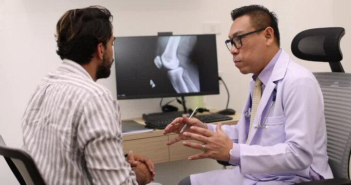 Doctor pointing on the knee problem point on x-ray film. x-ray film show skeleton knee on film. Surgery medical technology concept. Osteoarthritis in the