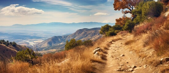 An autumn day along a mountain ridgeline offers a desert trail with a captivating view. Creative banner. Copyspace image - Powered by Adobe