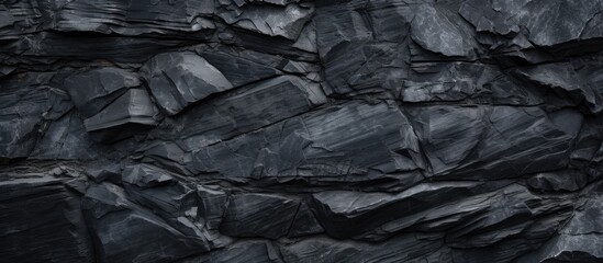 Fototapeta premium An abstract background or texture featuring a black stone on a slate like surface Perfect for copy space images