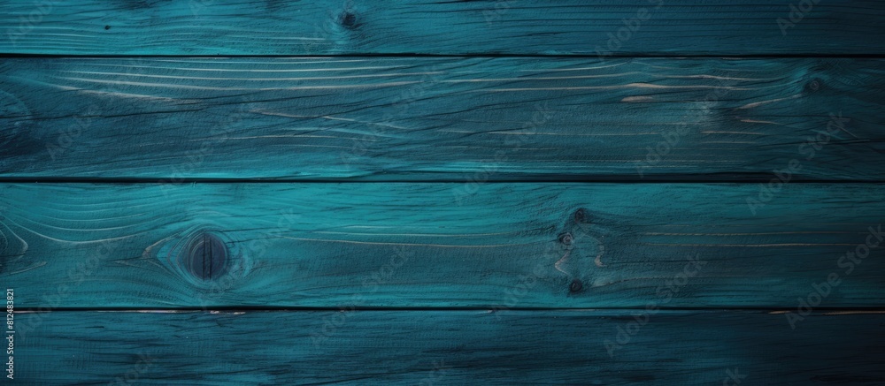 Poster an unevenly colored wooden board in a dark blue green shade creating an abstract background for the 