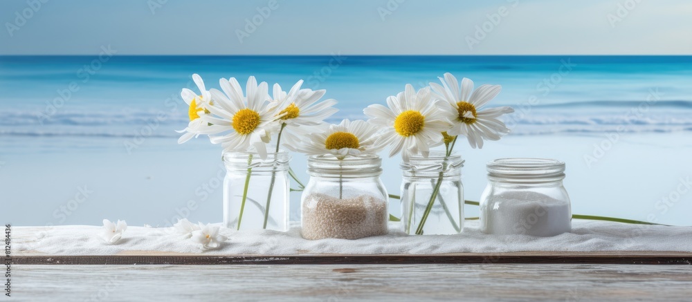 Poster on the table there are three banks containing sea salt and flowers creating a copy space image