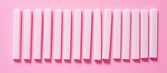 Fototapeta premium A flat lay of delicious chewing gum sticks arranged on a pink backdrop providing ample space for accompanying text