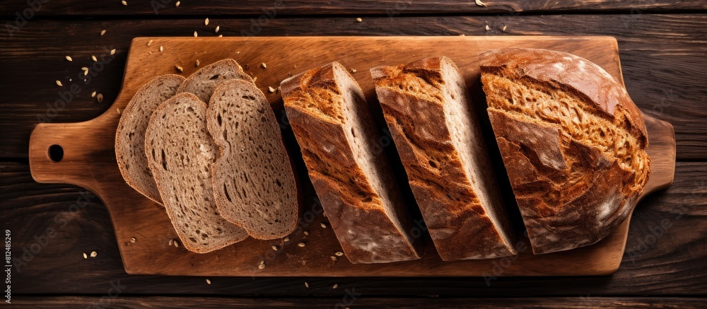 Poster a beautiful arrangement of freshly baked sliced rye bread on a wooden cutting board captured from ab