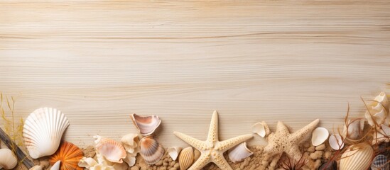 A close up summer frame of seashells starfish and old paper on a wooden background creates a beautiful sea composition Includes copy space image