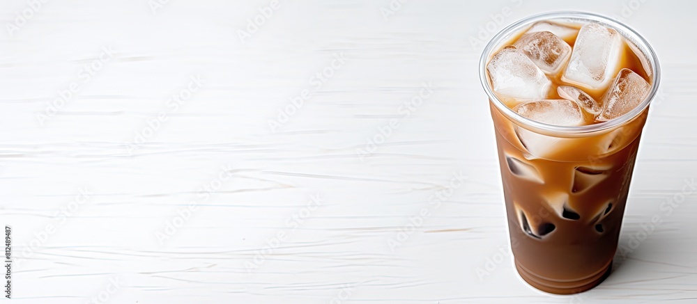 Poster a refreshing cup of iced coffee placed on a blank white surface providing a perfect copy space image