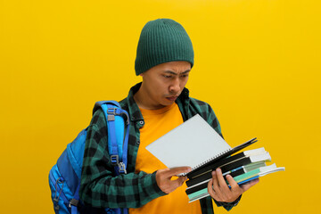A pensive young Asian student, dressed in a beanie hat and casual shirt, carrying a backpack and...