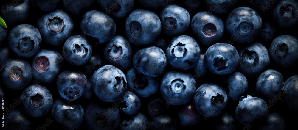 Poster A top down view of ripe organic blueberries arranged on a black background capturing the essence of summer berries The image features a flat layout with ample copy space