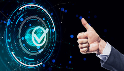 Businessman hand showing thumbs up with glowing digital checkmark hologram on dark blue polygonal...