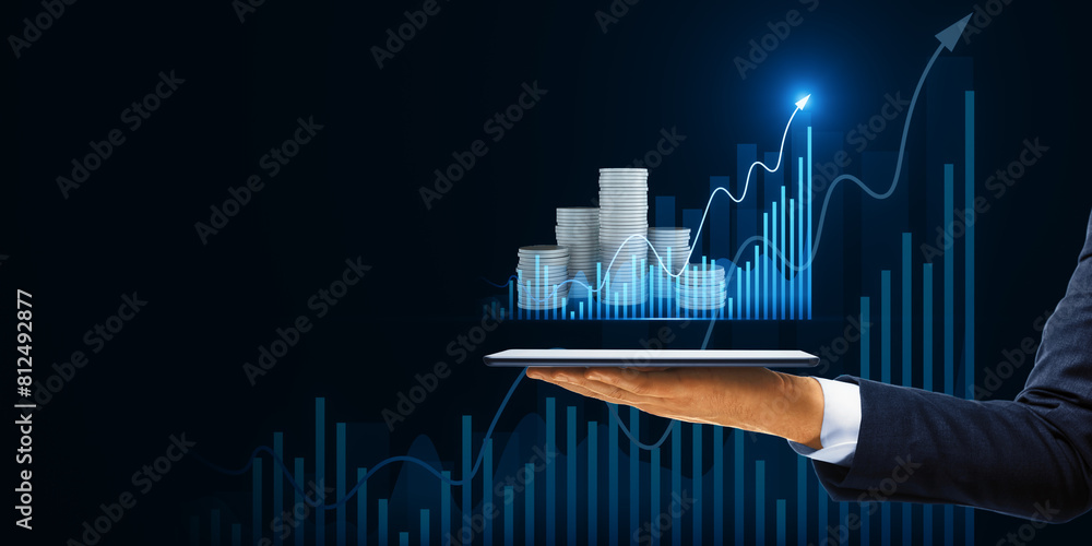 Poster close up of male hand holding cellphone with creative hologram with growing chart and stacked coins 