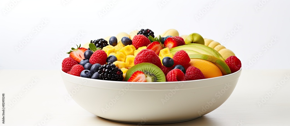 Aufkleber closeup of a bowl full of fresh fruits and vegetables arranged against a white background creating a