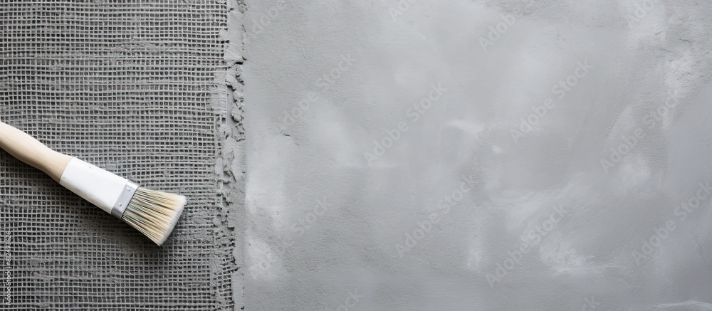 Aufkleber Gray concrete background with a roll of mesh for plastering and a putty knife seen from a top down perspective Copy space image available