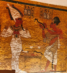 Wall relief of Pharoah Ay performing the opening of the mouth ritual on Tutankhamun inside the...