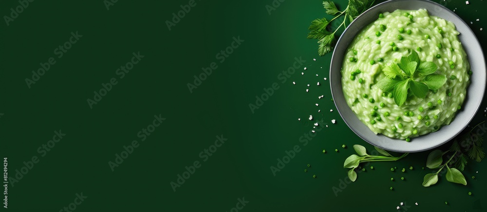 Poster a bowl of homemade creamy green pea risotto photographed from above with plenty of space for text on