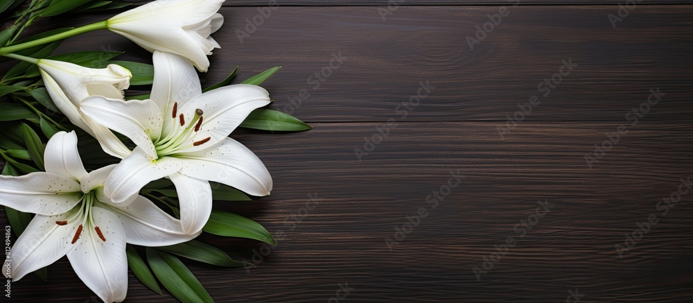 Poster a copy space image of a white greeting card and craft envelope adorned with lilies flowers placed on