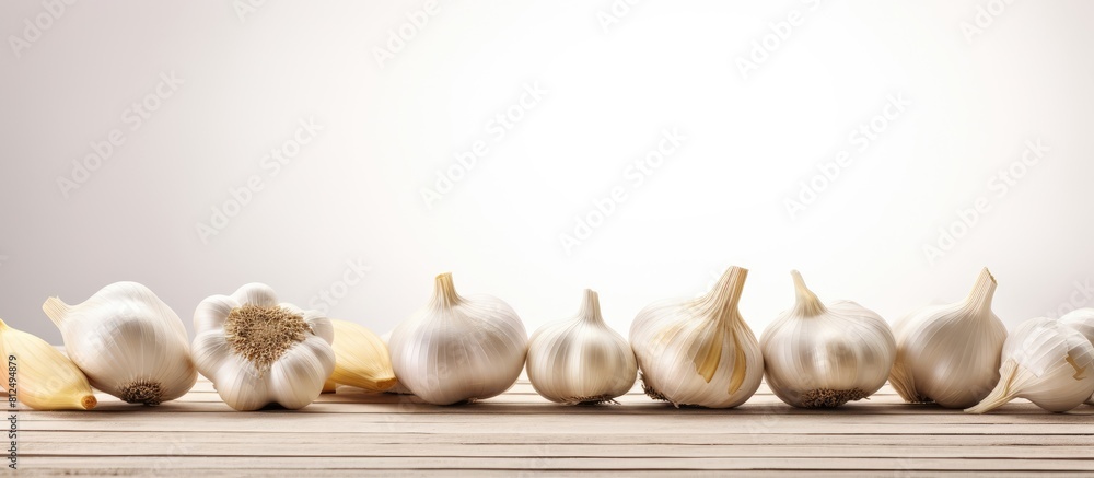 Poster A copy space image of organic garlic fresh and aromatic placed on a clean white wooden table with room for adding text