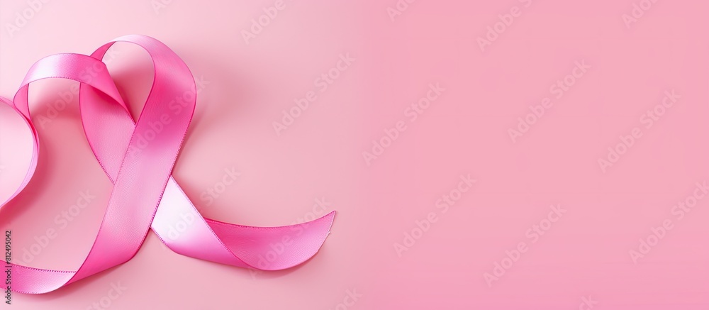 Poster a copy space image of a cancer disease awareness symbol portrayed as a pink ribbon placed on top of 