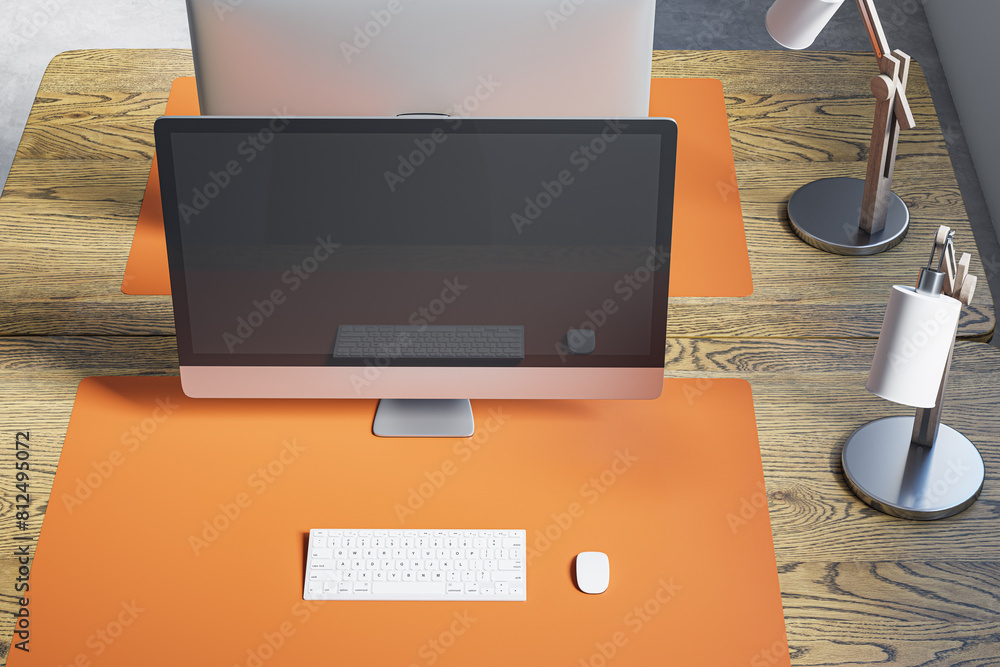 Poster Close up and above view of designer office table with mock up computer display on wooden desk, rug, lamp and other items. Mock up, 3D Rendering.