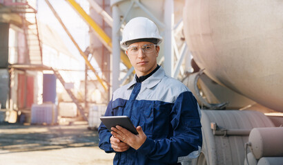 Banner modern control construction site, engineer working with computer tablet on background cement...