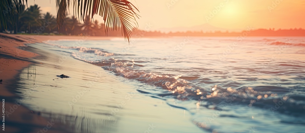 Poster The image features a hazy sunset on a tropical beach with the sunlight creating a bokeh effect on the water It evokes the idea of a summer vacation and travel adventure with a vintage tone filter add