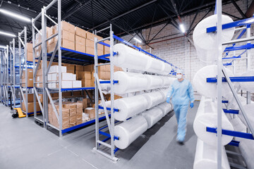 Concept medicine factory for production health. Worker of warehouse on roll non woven medical...