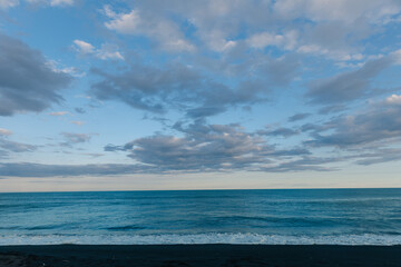 Landscape of Khalaktyrsky beach with black volcanic sand coast of North Pacific Ocean Kamchatka Russia sunset