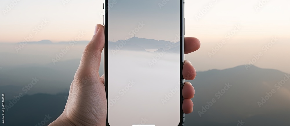 Poster In the morning a man s hand taps on a smartphone with a white screen while a television screen serves as the background The smartphone s screen is blank providing space for information