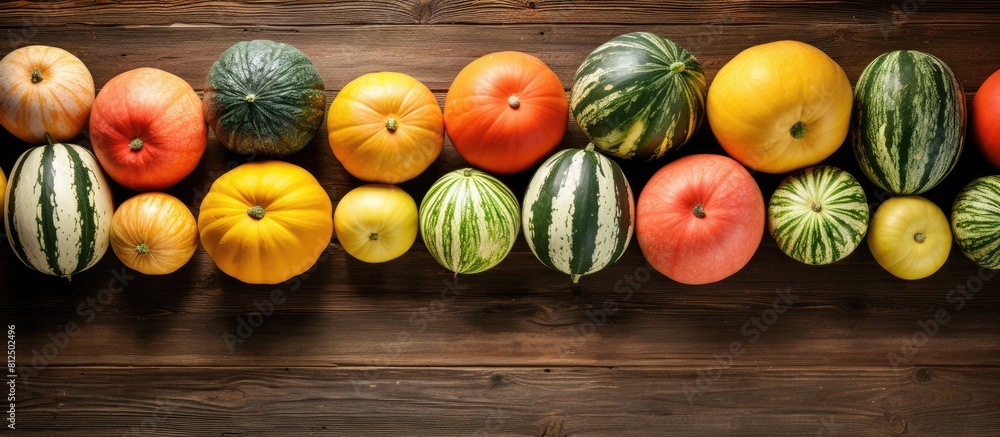 Poster A mouthwatering assortment of freshly picked melons displayed on a rustic wooden table captured from above Plenty of room for adding text in the copy space image