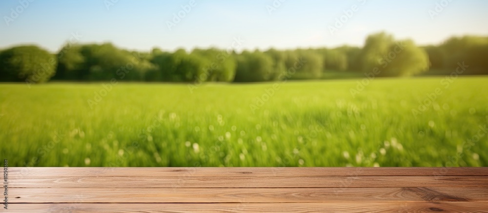 Aufkleber wooden deck table placed against a green field background creating an empty material for a product d