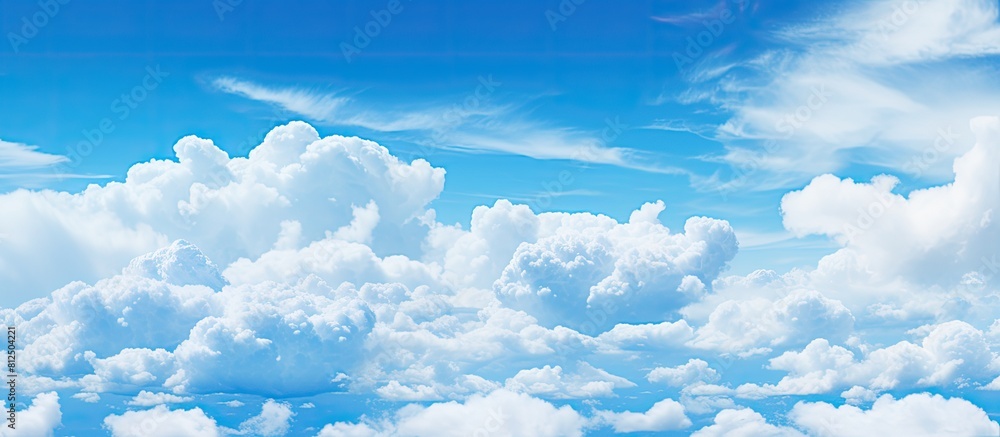 Aufkleber Clouds provide a stunning contrast against the vivid blue sky creating a captivating image with ample copy space