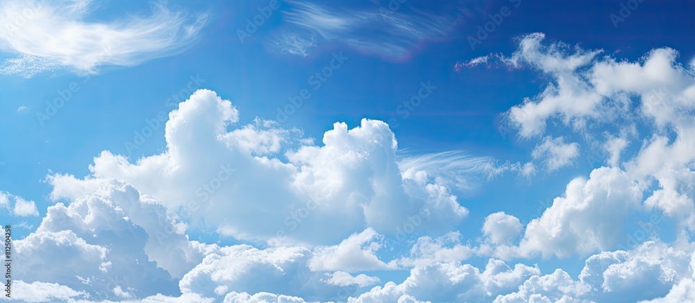 Aufkleber Clouds provide a stunning contrast against the vivid blue sky creating a captivating image with ample copy space