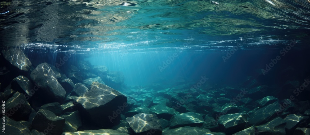 Poster Underwater rocks create an abstract water texture in this image providing ample copy space