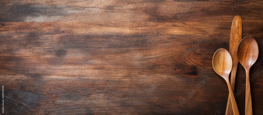 Poster A rustic wooden table with a pair of artisanal wooden spoon and fork on top leaving empty space for an image. Creative banner. Copyspace image