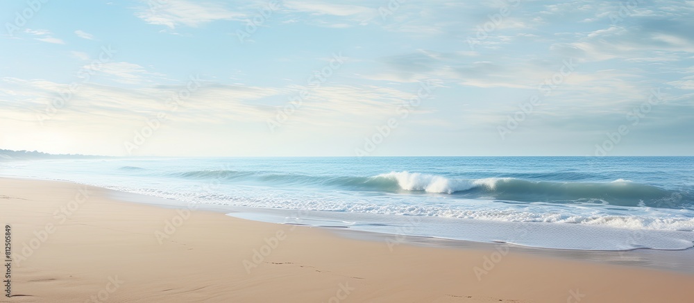 Poster a serene beach scene with sandy shore and gentle waves creating a peaceful morning ambiance perfect 