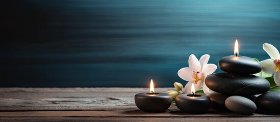 A serene arrangement of candles and spa stones on a wooden backdrop creates a captivating copy space image