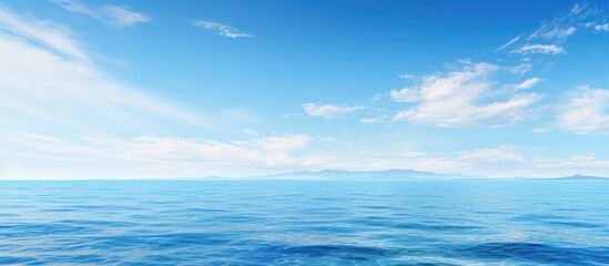 Fototapeta premium A serene background featuring the expansive sea and a clear blue sky with ample space for adding images or text