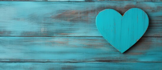 A heart shaped wooden message for Valentine s Day made from upcycled palette rests on a vibrant turquoise backdrop with room for other elements. Creative banner. Copyspace image