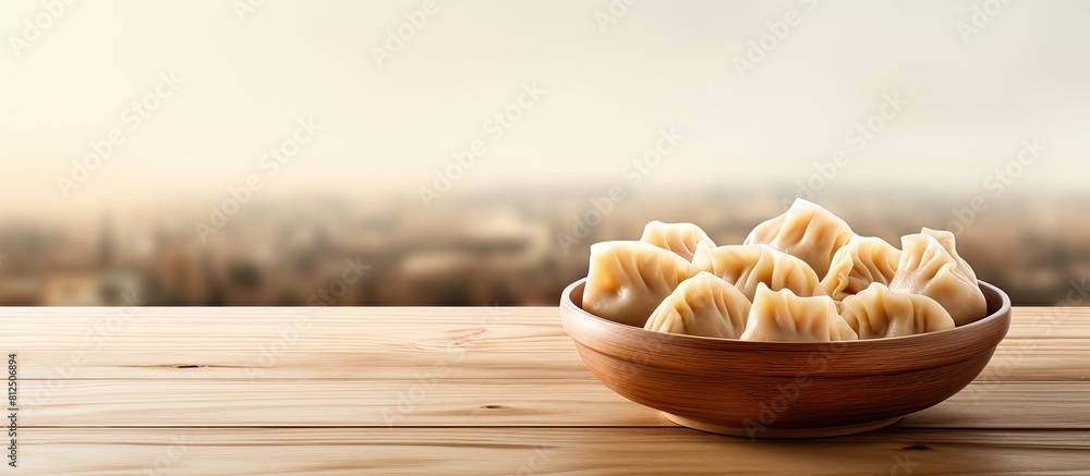 Poster a delicious bowl of dumplings sits on a wooden table with ample copy space for the image