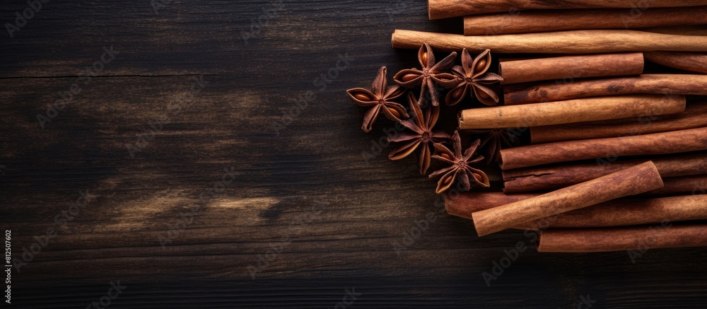 Aufkleber Top view of cinnamon sticks on a dark wooden background creating a captivating copy space image This condiment is perfect for making mulled wine