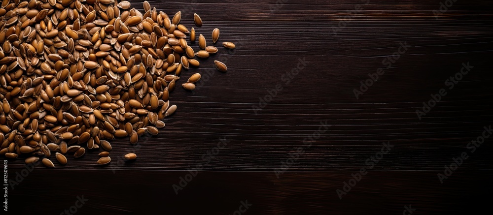 Leinwandbilder a top down view of golden and brown flax seeds on a dark wooden surface creating a visually appealin