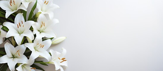 A top down view of a condolence card featuring white lilies with ample blank space for images